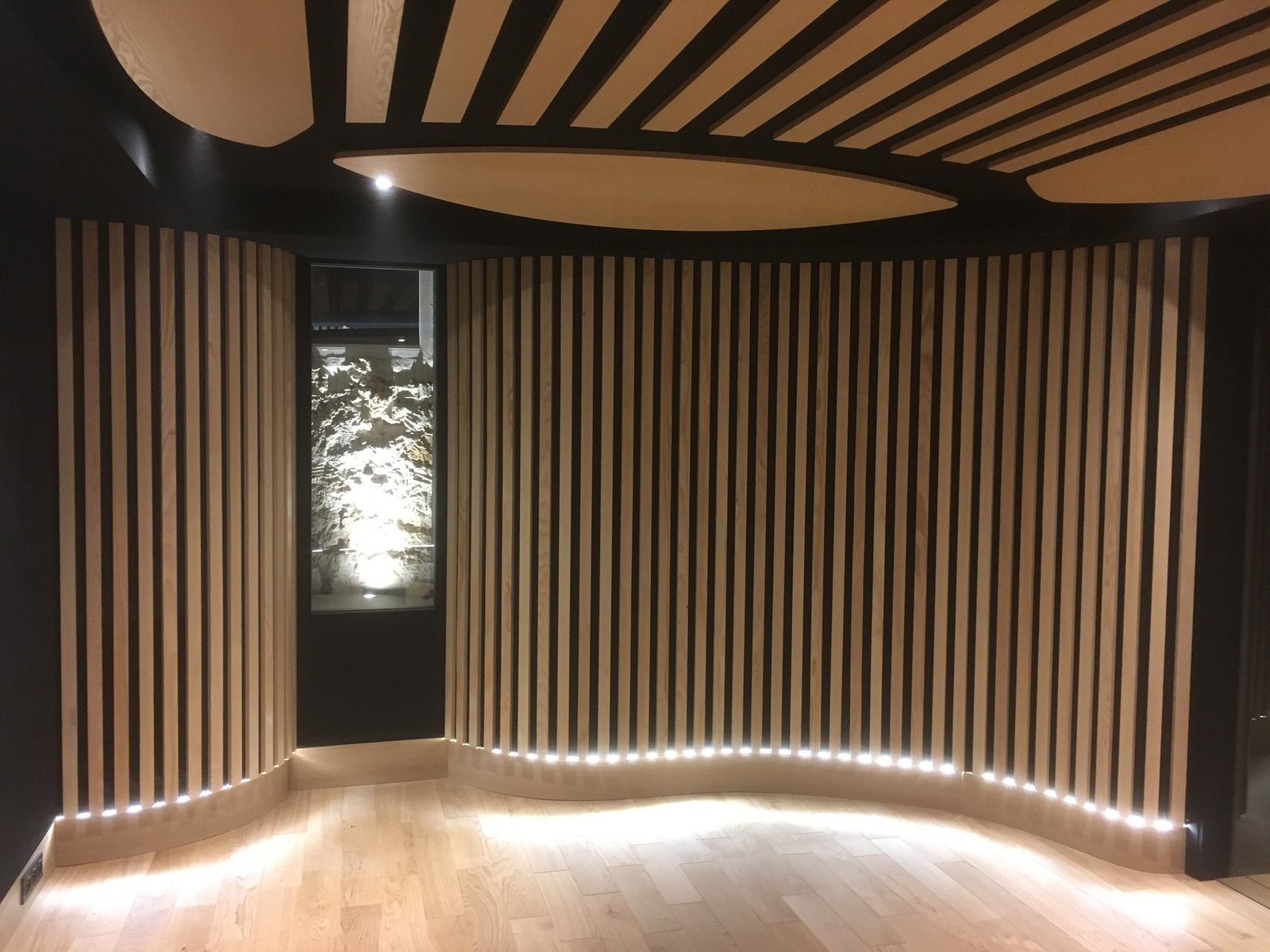 Wood acoustic slat panel in a completed interior